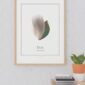 Teal feather art print on wall above plant