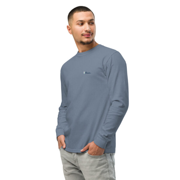 unisex-garment-dyed-heavyweight-long-sleeve-shirt-blue-jean-left-front-68dfdaf0d9a82.jpg Man in blue long-sleeve shirt, hands in pockets.