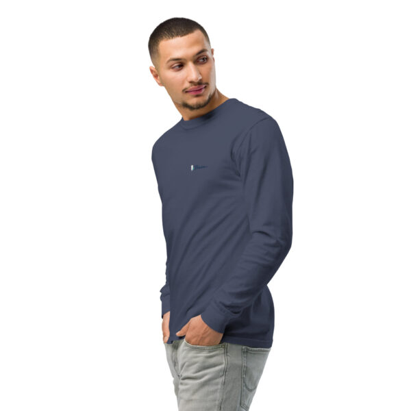 unisex-garment-dyed-heavyweight-long-sleeve-shirt-navy-left-front-2-68e008b1c3d42.jpg Man wearing navy long-sleeve shirt and jeans.