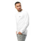 Man in white long-sleeve shirt poses confidently.