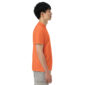 Profile of person in orange shirt and gray shorts.